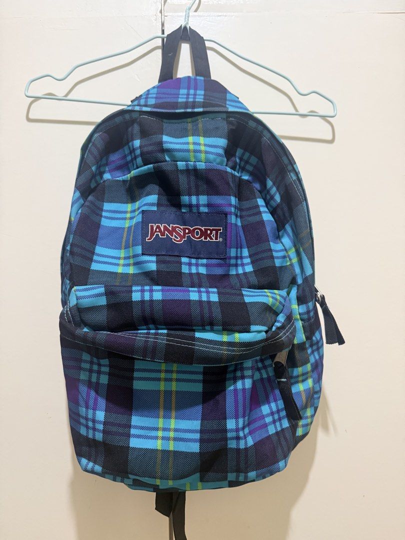 JanSport Blue Plaid Backpack (Category: Backpacks) located in Batac City. Submitted by chocofromage (Listing ID 1471167260, Image 1). Description: - Authentic JanSport backpack - Eye-catching blue, purple, and green plaid design - Spacious main compartment fits books, laptops, and daily essentials - Classic front pocket with secure zipper closure - Sturdy black top handle and adjustable straps for comfortable carrying - Versatile for school, work
