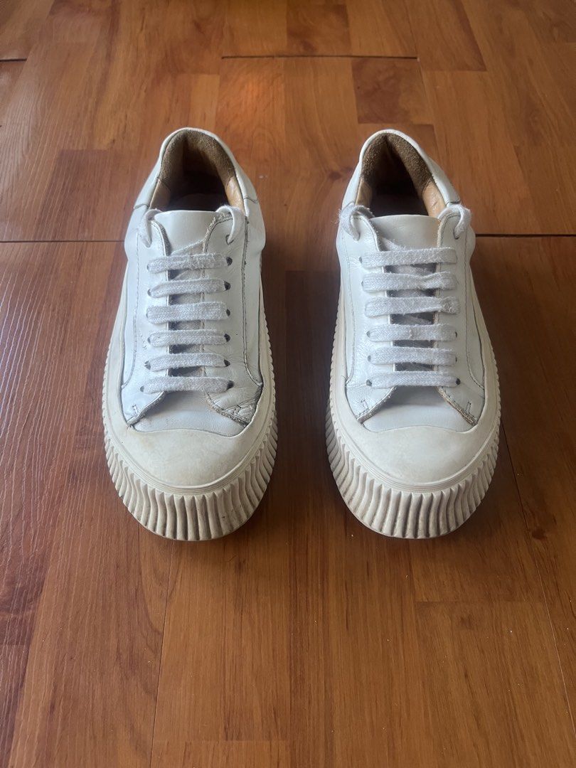 Jil Sander Off-White Leather Chunky Ribbed Platform Sneakers (Category: Sneakers) located in Lipa City. Submitted by alexcollectionco (Listing ID 1471283679, Image 1). Description: Authentic luxury platform sneakers from Jil Sander. Features thick, premium off-white leather uppers, plush tan leather interior lining with stamped branded insoles, and Jil Sander’s iconic heavy ribbed/grooved vulcanized platform rubber soles. Delivers a bold minimali