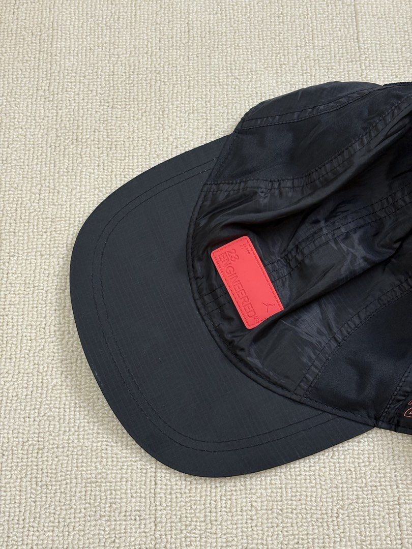 Jordan 23 Engineered Black Cap Hat (Category: Caps & Hats) located in Manila. Submitted by porma.market (Listing ID 1471272557, Image 1). Description: - Authentic Jordan 23 Engineered cap in versatile black - Eye-catching red rubber front logo patch and side text detailing - Adjustable back strap equipped with a secure red buckle - Made from 100% lightweight and durable polyester - Impeccable, clean condition inside and out - Perfect everyday acc