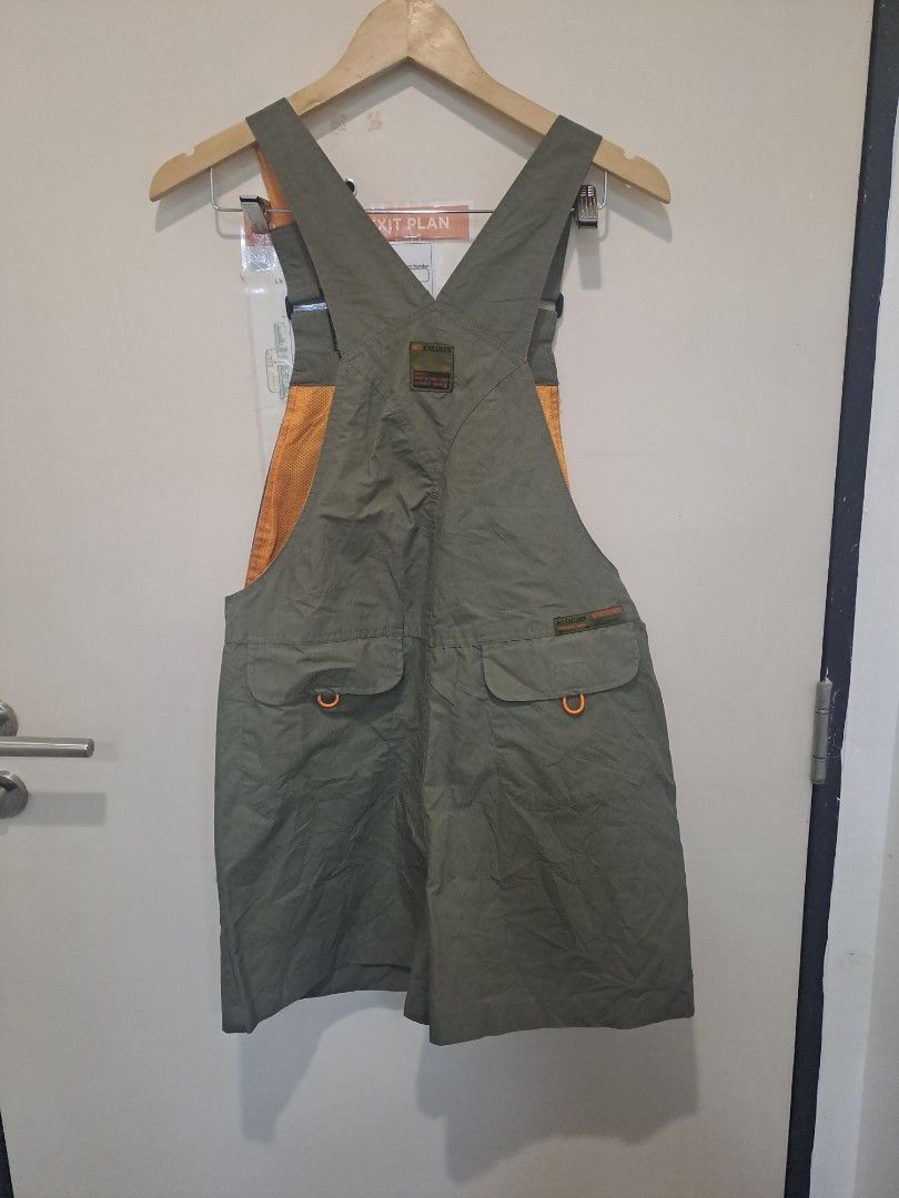 Jumpsuit short (Category: Activewear) located in Manila. Submitted by joanbalde39643 (Listing ID 1471197304, Image 2). Description: The item in the image is the Passenger Shuffle Light Cotton Short Dungarees in the "Wild Green" colorway. [1] These outdoor-inspired shortalls feature a lightweight green cotton construction accented by a bright orange lining on the bib and shoulder straps, along with distinctive orange detailing around the pockets a