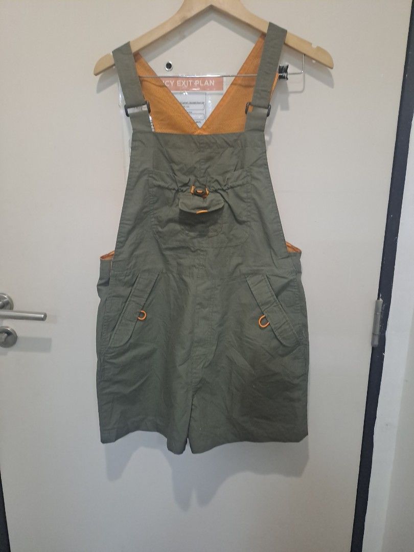 Jumpsuit short (Category: Activewear) located in Manila. Submitted by joanbalde39643 (Listing ID 1471197304, Image 1). Description: The item in the image is the Passenger Shuffle Light Cotton Short Dungarees in the "Wild Green" colorway. [1] These outdoor-inspired shortalls feature a lightweight green cotton construction accented by a bright orange lining on the bib and shoulder straps, along with distinctive orange detailing around the pockets a
