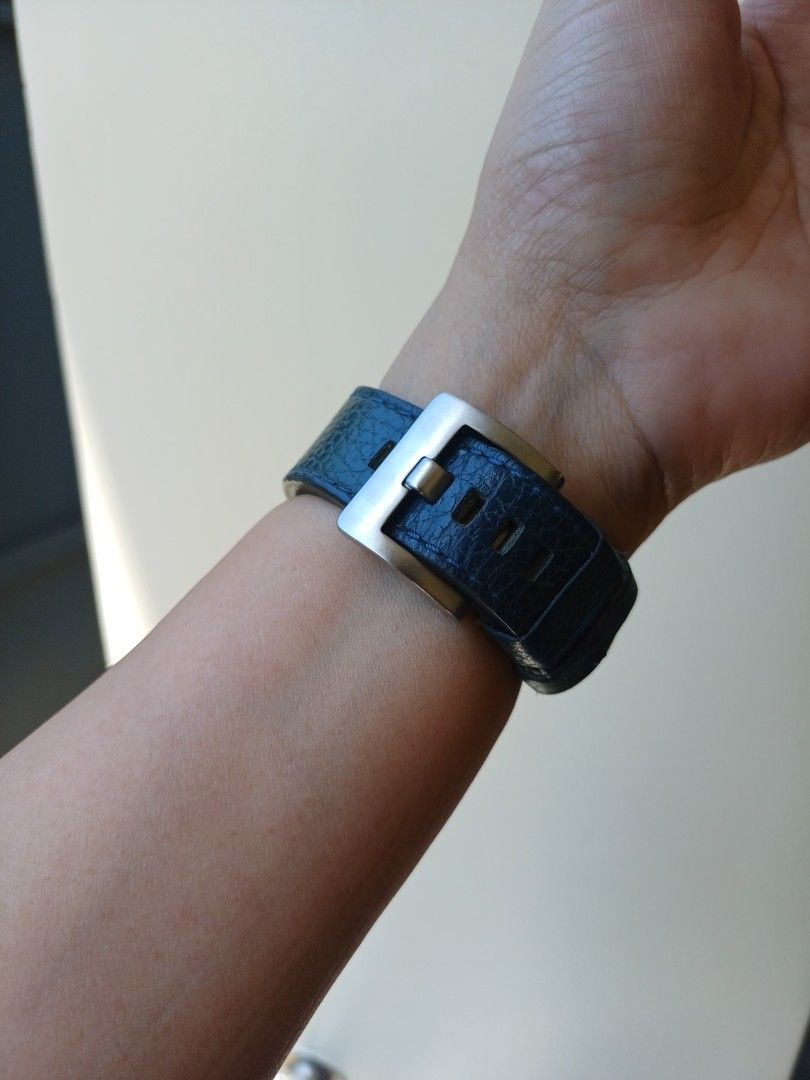 Kenneth Cole rectangular wristwatch with blue leather strap (Category: Women's Watches) located in Antipolo. Submitted by momprelovedpage (Listing ID 1471216227, Image 3). Description: - Brand: Kenneth Cole - Movement: Quartz - Case: Rectangular, silver-tone with stainless steel back - Dial: Dark blue with clear numbering - Strap: Textured dark blue leather with metal stud accents and buckle closure - Condition: Excellent / Well-maintained - Perf