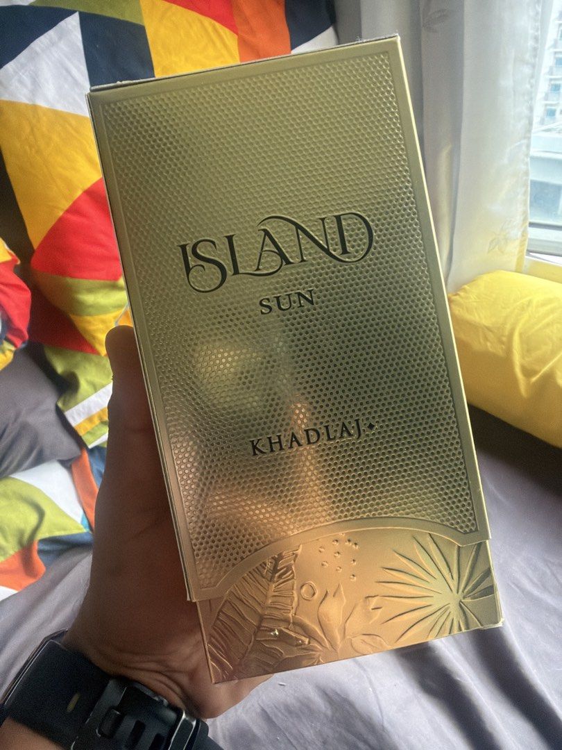 Khadlaj Island Sun Perfume (Category: Fragrance & Deodorants) located in Makati City. Submitted by alexg0420 (Listing ID 1471152782, Image 1). Description: - Brand: Khadlaj Island Sun - Missing may 4-5 sprays only - Condition: Brand new, factory sealed - Packaging: Gold-colored textured box with embossed tropical leaf details - Perfect as a gift for fragrance lovers - Delivery and meetup options available.