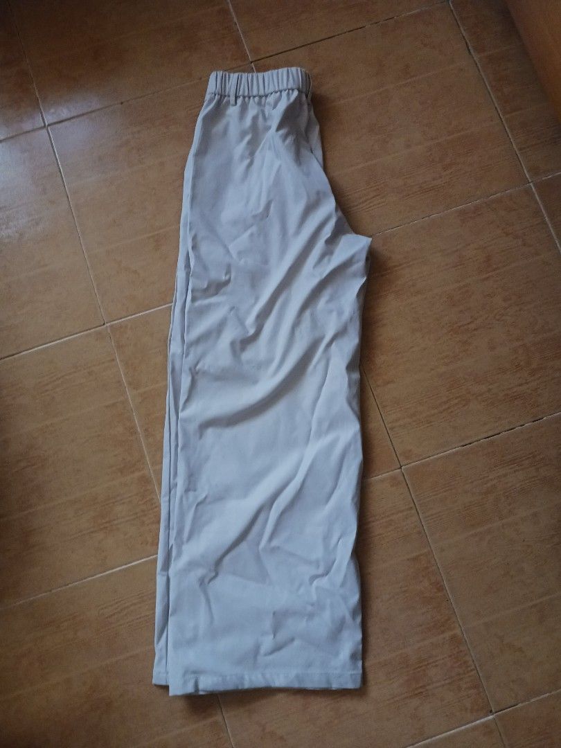 Khaki Colored Trouser Pants (Category: Trousers) located in Manila. Submitted by fawknija (Listing ID 1471152391, Image 2). Description: - Color: Khaki - Fit: Straight cut, flat-front (no pleats) - Closure: Zipper fly with button waist - Pockets: Standard side pockets - Fabric: Lightweight and comfortable - Styling: Neutral tone, perfect for casual or office wear.