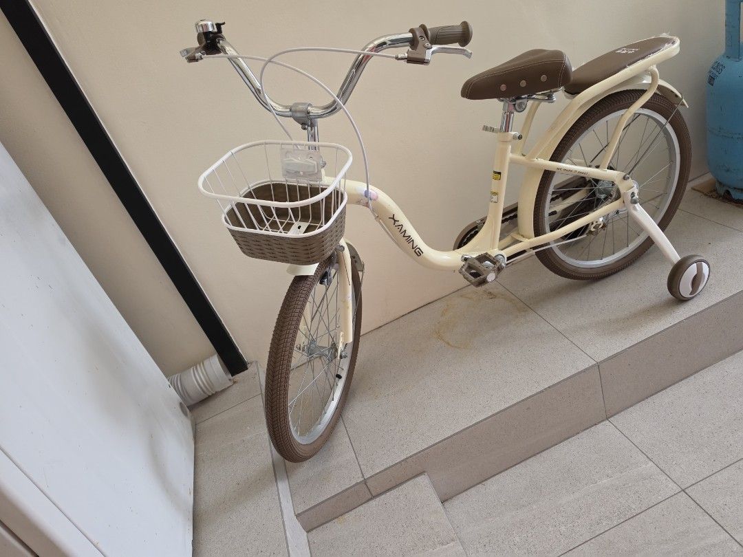 Kids Bicycle Cream with Training Wheels Size 20 (Category: Bicycles) located in Quezon City. Submitted by 888eunice (Listing ID 1471199237, Image 2). Description: - Kids Bicycle - Color: Cream with stylish brown seat, handlebars, and matching tires - Extras: Includes a handy front basket and rear rack for toys - Safety & Learning: Comes with removable training wheels - Features: Upright handlebars equipped with a fun bell on the left side - Condi