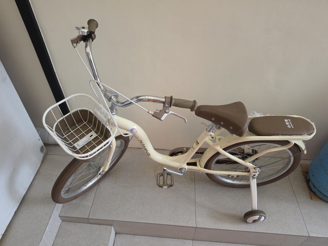 Kids Bicycle Cream with Training Wheels Size 20 (Category: Bicycles) located in Quezon City. Submitted by 888eunice (Listing ID 1471199237, Image 3). Description: - Kids Bicycle - Color: Cream with stylish brown seat, handlebars, and matching tires - Extras: Includes a handy front basket and rear rack for toys - Safety & Learning: Comes with removable training wheels - Features: Upright handlebars equipped with a fun bell on the left side - Condi