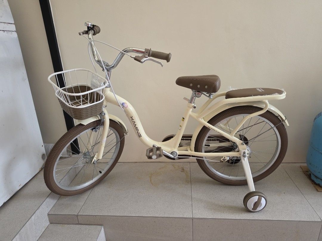 Kids Bicycle Cream with Training Wheels Size 20 (Category: Bicycles) located in Quezon City. Submitted by 888eunice (Listing ID 1471199237, Image 1). Description: - Kids Bicycle - Color: Cream with stylish brown seat, handlebars, and matching tires - Extras: Includes a handy front basket and rear rack for toys - Safety & Learning: Comes with removable training wheels - Features: Upright handlebars equipped with a fun bell on the left side - Condi