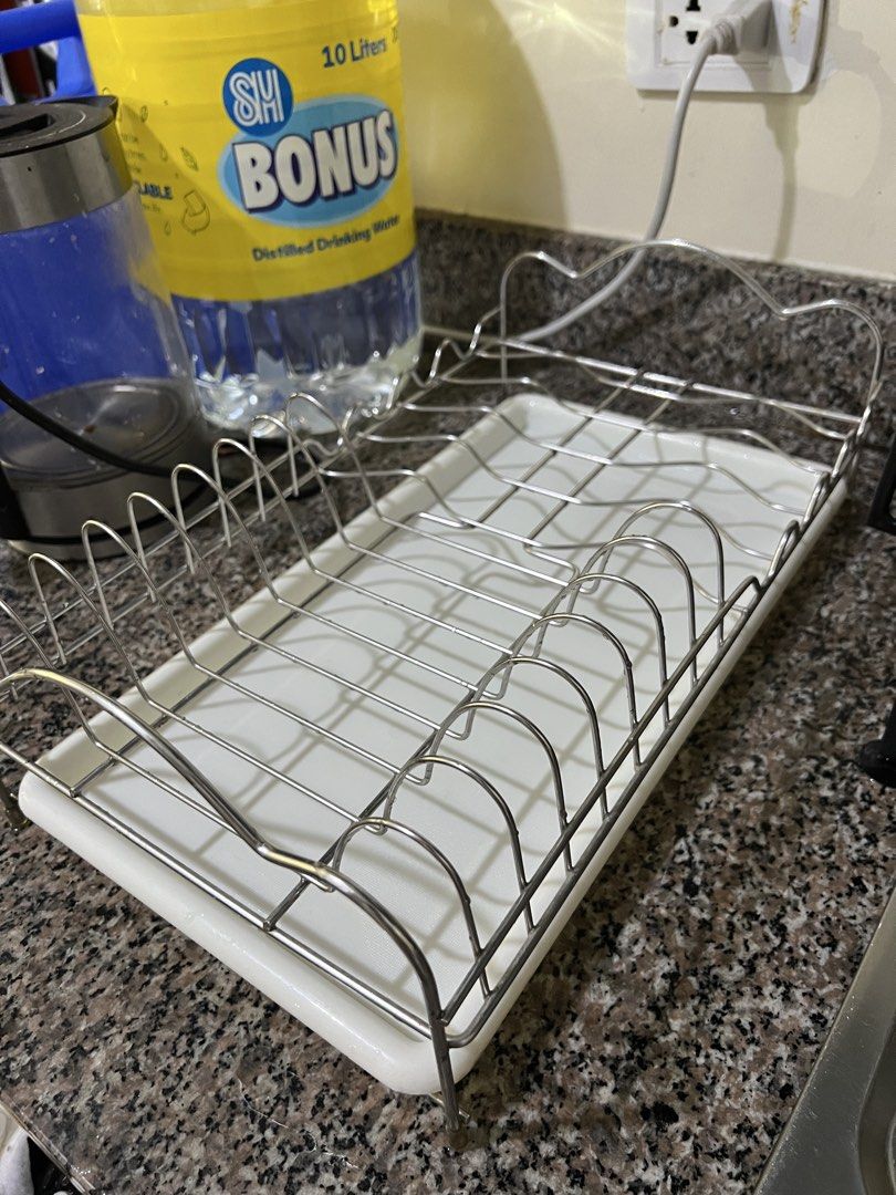 Kitchen Dish Drying Rack with White Tray (Category: Bathroom & Kitchen Fixtures) located in Manila. Submitted by renattahan (Listing ID 1471285640, Image 1). Description: Chrome wire dish rack with a removable white plastic drain tray. Features plate and bowl slots on both sides and a flat center space. Perfect for keeping your kitchen counters dry, organized, and clutter-free..