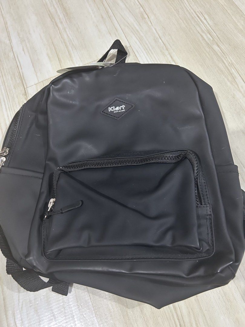 Klart Black Water Resistant Casual Backpack (Category: Babies & Kids Fashion) located in Manila. Submitted by ai010 (Listing ID 1471213613, Image 1). Description: - Brand new Klart black backpack with original Japanese price tag still attached - Smooth matte finish, water-resistant material to keep your belongings safe - Front zippered pocket for quick access to small items - Spacious main compartment with secure double zippers - Adjustable shoul