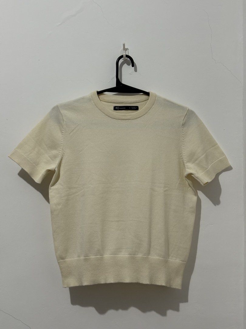 Knitted Tops with mendings (Category: Blouses) located in Manila. Submitted by coolphoenix_f1e702 (Listing ID 1471226856, Image 1). Description: - Brand: MO Essentials - Size: M - Color: Cream - Style: Short sleeve knit top with round neckline, ribbed hem, and cuffs - Condition: Excellent, clean with no flaws - Versatility: Perfect for layering or wearing solo Knitted Overruns with mendings .