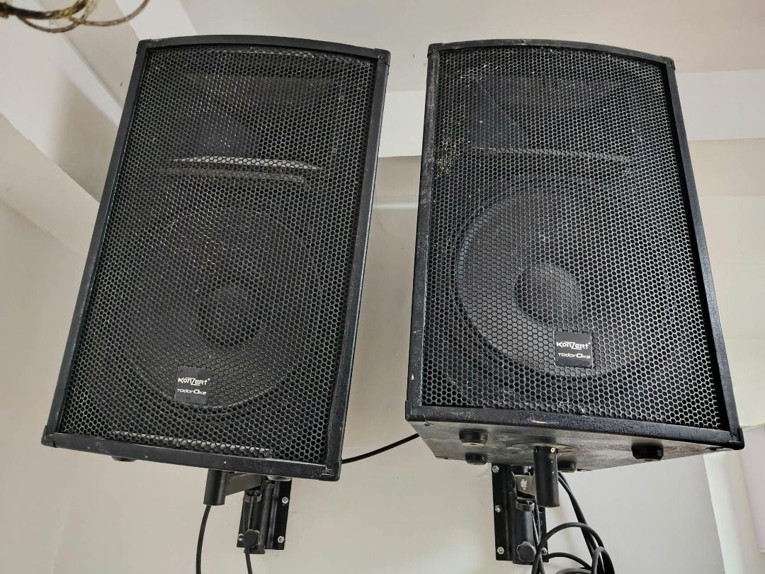 Konzert Audio Setup with Mixer and Speakers (Category: Soundbars, Speakers & Amplifiers) located in Muntinlupa City. Submitted by greenbloomer (Listing ID 1471242319, Image 1). Description: - Complete audio setup ready for use - Includes Konzert audio mixer with standard knobs, sliders, and audio inputs - Two black wall-mounted speakers with metal grilles and visible branding - Comes with mounting brackets and necessary cables - Pulled from a wor