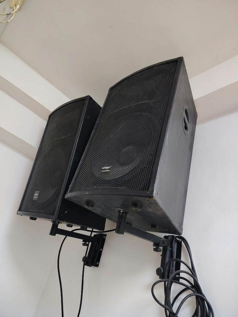 Konzert Audio Setup with Mixer and Speakers (Category: Soundbars, Speakers & Amplifiers) located in Muntinlupa City. Submitted by greenbloomer (Listing ID 1471242319, Image 2). Description: - Complete audio setup ready for use - Includes Konzert audio mixer with standard knobs, sliders, and audio inputs - Two black wall-mounted speakers with metal grilles and visible branding - Comes with mounting brackets and necessary cables - Pulled from a wor