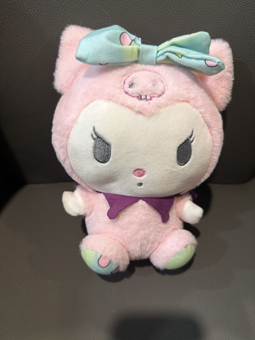 Kuromi Pink Pastel Plush Toy (Category: Plushies & Soft Toys) located in San Juan City. Submitted by lilminey (Listing ID 1471242162, Image 1). Description: - Authentic Kuromi pink plush toy in a cute sitting posture - Features a light blue and green patterned bow and a purple collar - Detailed embroidered skull design on the hood - Made with ultra-soft, clean fabric - Well-maintained and perfect for collectors or gifts.