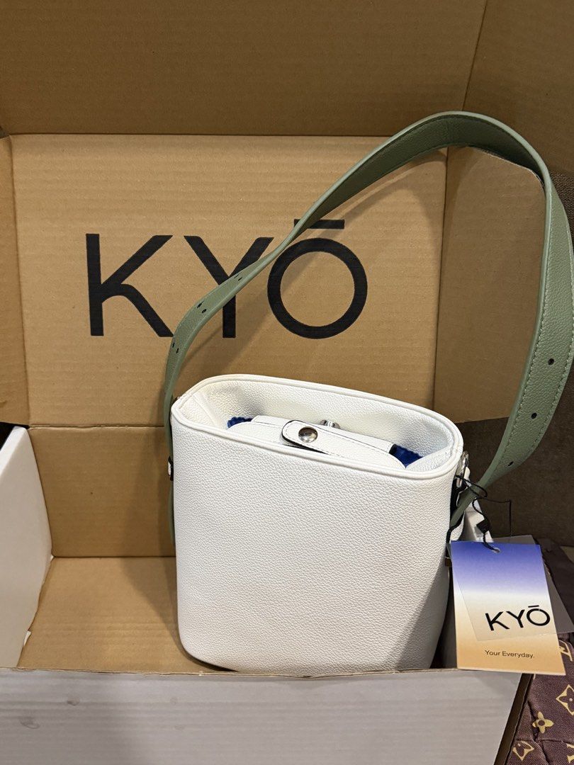 KYŌ White and Green Bucket Bag (Category: Shoulder Bags) located in Cainta. Submitted by madmaaax (Listing ID 1471228114, Image 1). Description: - Brand: KYŌ - Color: White with green shoulder strap and blue inner lining - Closure: Magnetic snap on inner flap - Condition: Brand new with tag still attached - Inclusions: Original branded box included .