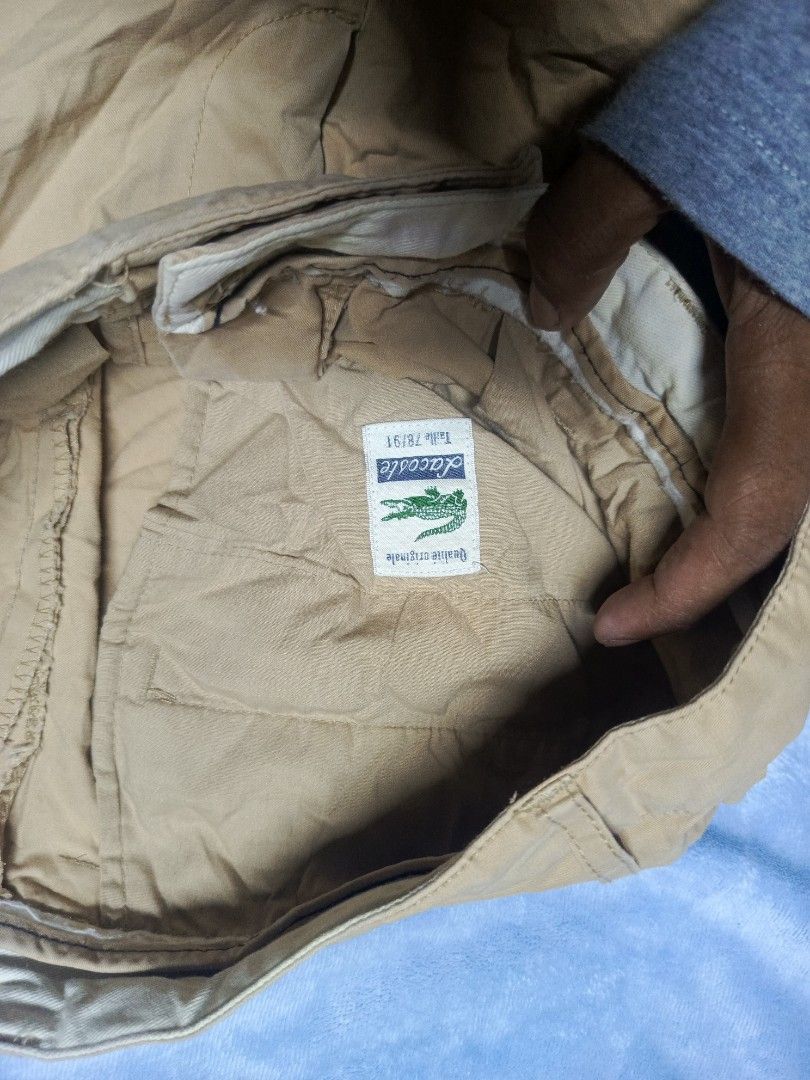 Lacoste Beige Chino Shorts (Category: Shorts) located in City of Isabela. Submitted by warmbird.d06e6f (Listing ID 1471136640, Image 3). Description: - Brand: Lacoste - Color: Classic Beige / Khaki - Size: 78/91 - Fit: Classic fit - Details: Two back welt pockets with button closure and iconic embroidered green crocodile logo on the rear right pocket - Condition: Excellent for everyday casual wear size 30 .