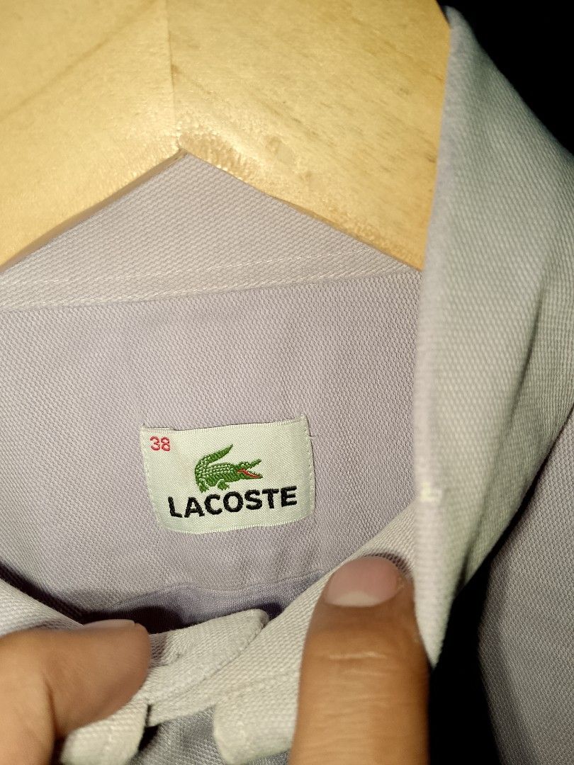 Lacoste button-down long sleeve shirt size 38 lilac (Category: Longsleeves) located in Manila. Submitted by mjthrifted_second (Listing ID 1471193249, Image 2). Description: - Brand: Lacoste (Manufactured by Devanlay) - Color: Light purple / Lilac - Size: 38 -Dimes: 20/28 - Material: 100% Cotton - Design: Classic button-down with front chest pocket and signature green crocodile logo - Sleeves: Long sleeves with button cuffs - Condition: Excellent 