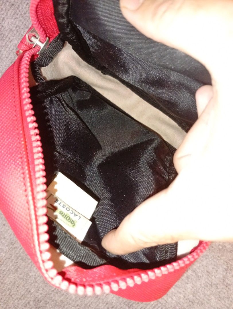 Lacoste Red Crossbody Bag with Adjustable Strap (Category: Cross-body Bags) located in Cebu City. Submitted by jeanyrose46 (Listing ID 1471281864, Image 3). Description: - Brand: Lacoste - Color: Bright Red - Style: Structured crossbody bag with adjustable shoulder strap and metal hardware - Exterior: Front zipped pocket with debossed crocodile logo patch - Interior: Lined in black fabric with internal brand tag - Size: Compact, ideal for daily e
