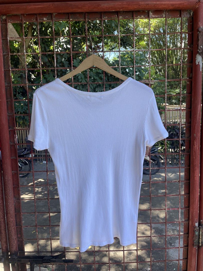 Lacoste White Ribbed Button-Down Short Sleeve Top Size 40 (Category: Shirts) located in Polomolok. Submitted by madagascarts (Listing ID 1471120631, Image 2). Description: - Brand: Lacoste - Color: Clean White - Size: 40 (Tag attached) - Material: Soft Cotton and Modal blend - Origin: Made in Morocco - Design: Ribbed texture, short sleeves, scoop neckline, and partial front button placket - Detail: Iconic embroidered crocodile logo on the left ch