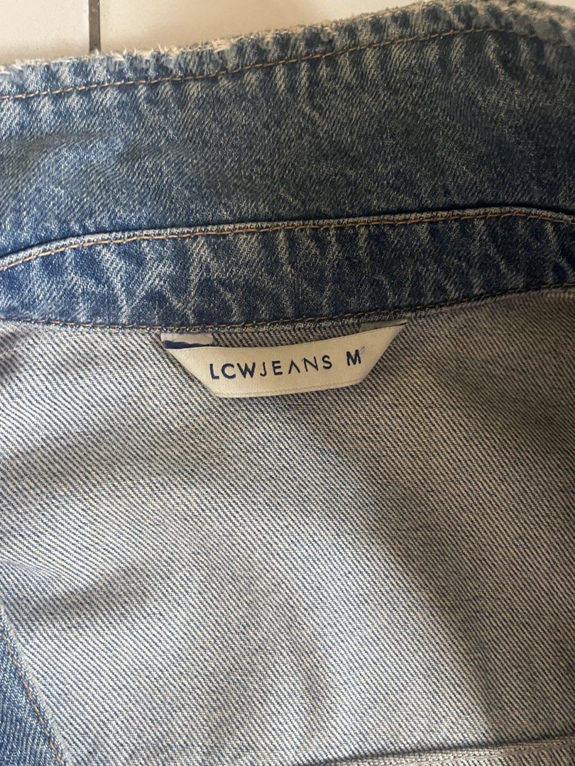 LCW Jeans Distressed Denim Jacket Size M (Category: Coats, Jackets and Outerwear) located in Bacolod City. Submitted by rrol_mll (Listing ID 1471136544, Image 2). Description: - Brand/Model: LCW Jeans Denim Jacket - Size: Medium (tag at collar) to Large - Wash: Classic light to medium wash - Fit: Regular fit, great for everyday wear - Details: Distress details on sleeves and hem - Closures & Pockets: Front button closure with metallic buttons, fu
