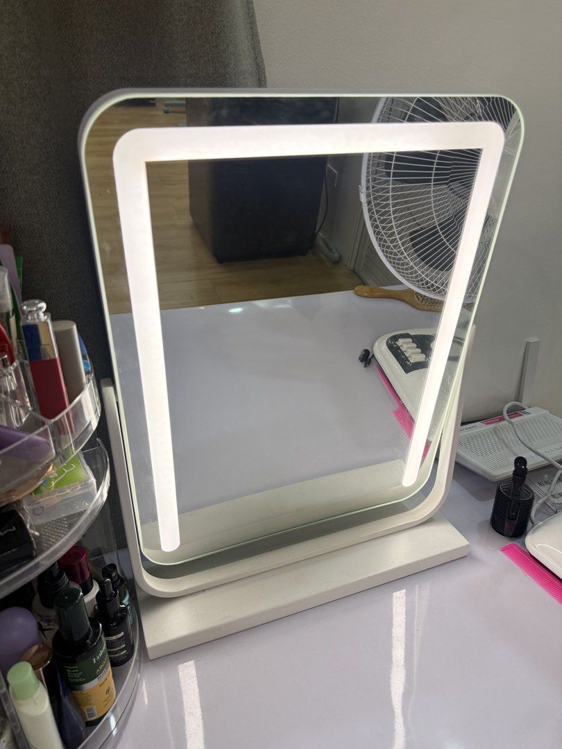LED Lighted Makeup Vanity Mirror with Stand (Category: Mirrors) located in Manila. Submitted by k.e9999 (Listing ID 1471259149, Image 3). Description: - Color: White tabletop design - Features: Built-in LED lighting around the frame with touch sensor power button - Function: Adjustable angle stand that rotates vertically - Condition: Fully working, bright lights, and clean glass surface with minimal dust - Stability: Sturdy base for secure placem