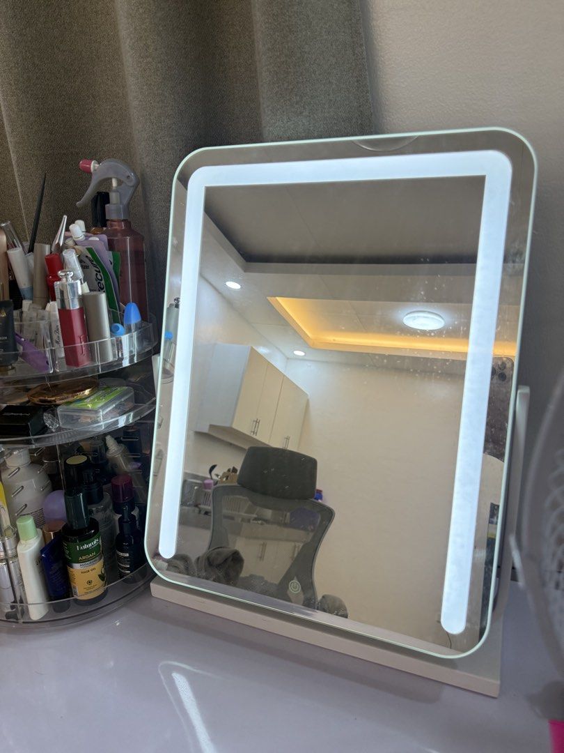 LED Lighted Makeup Vanity Mirror with Stand (Category: Mirrors) located in Manila. Submitted by k.e9999 (Listing ID 1471259149, Image 2). Description: - Color: White tabletop design - Features: Built-in LED lighting around the frame with touch sensor power button - Function: Adjustable angle stand that rotates vertically - Condition: Fully working, bright lights, and clean glass surface with minimal dust - Stability: Sturdy base for secure placem