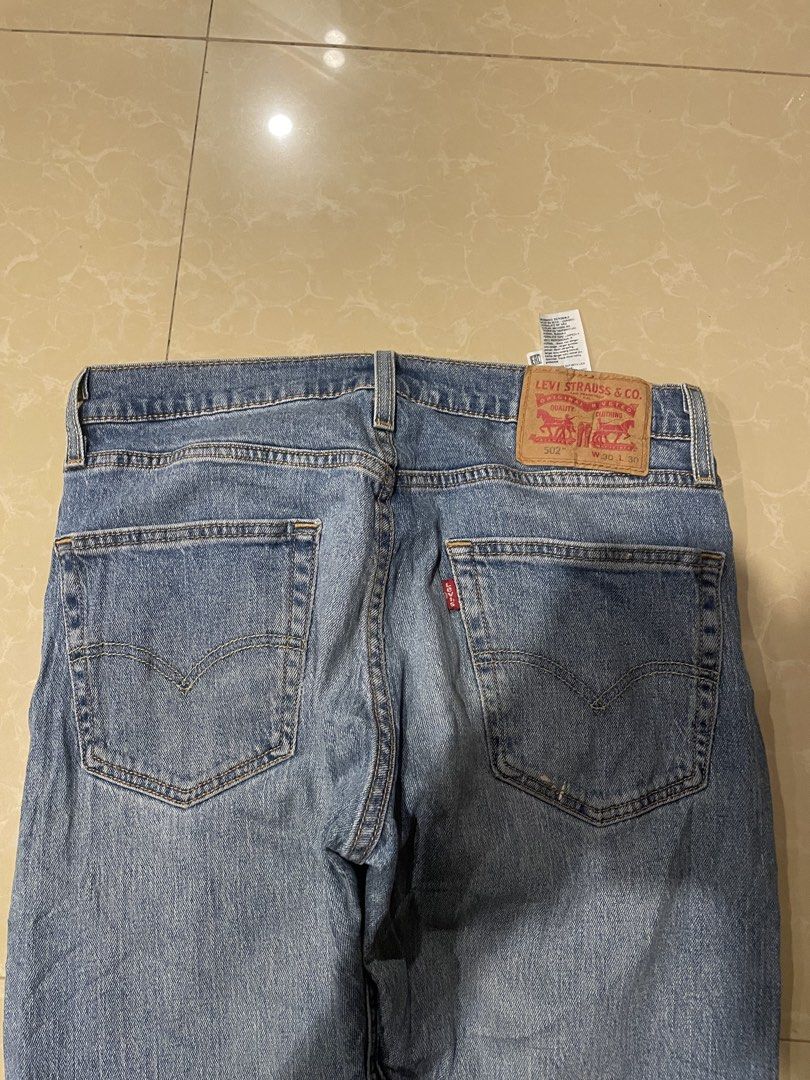 Levi's 502 Regular Taper Jeans W30 L30 (Category: Jeans) located in Davao. Submitted by loythrift30 (Listing ID 1471256917, Image 3). Description: - Brand/Model: Levi's 502 - Size: W30 L30 (marked on back leather patch) - Fit: Regular taper fit - Wash: Medium wash denim with light factory distressing - Details: Classic 5-pocket styling, button fly, copper rivets, and iconic red tab - Condition: Clean throughout with inner care tags intact.
