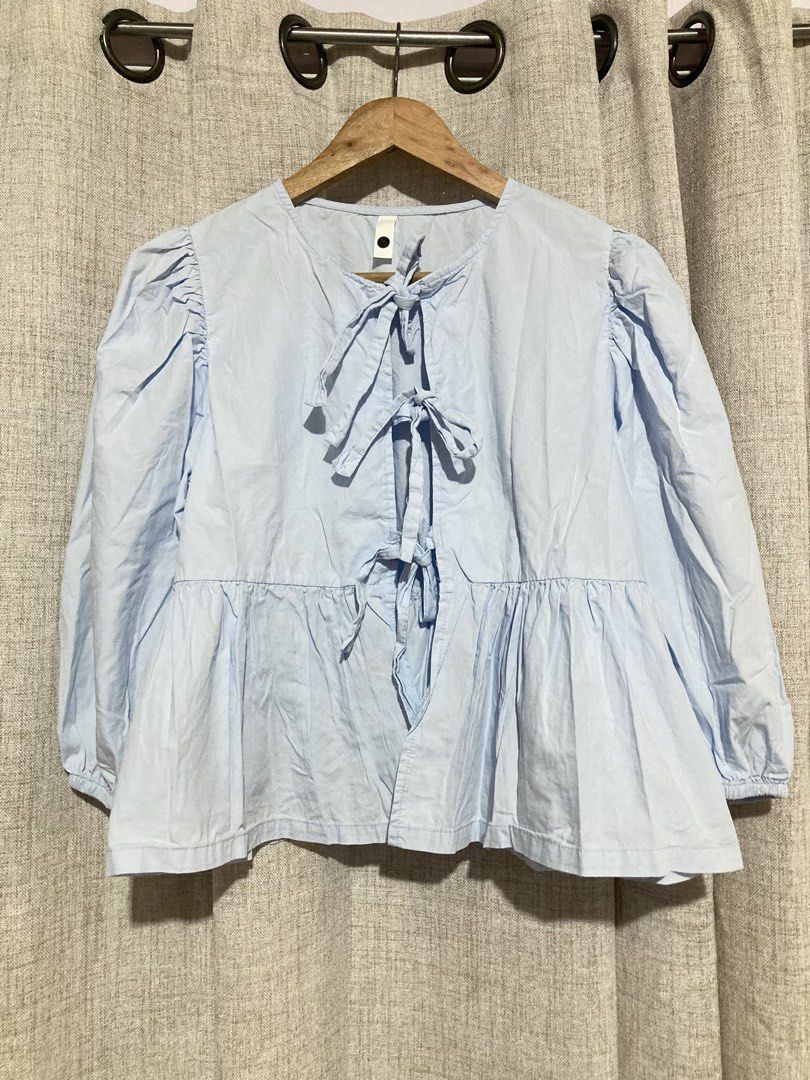 Light blue front-tie peplum blouse with puff sleeves (Category: Blouses) located in Meycauayan. Submitted by prettycloset.0310 (Listing ID 1471170740, Image 1). Description: Light blue cotton-blend blouse featuring front ribbon ties, puff sleeves, and a peplum waist. Medium. .