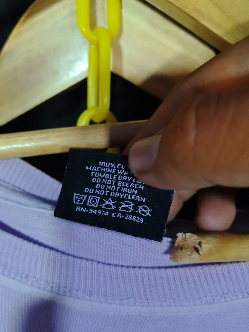Light Purple Cotton T-Shirt (Category: Shirts) located in Tagum. Submitted by corpuz_jerick02 (Listing ID 1471226286, Image 1). Description: - Color: Light purple pastel - Material: 100% cotton for all-day comfort - Fit: Standard crew neck design - Care: Machine washable and tumble dry low - Details: Features RN 94974 and CA 28629 on the inner tag - Condition: Simple everyday staple piece.