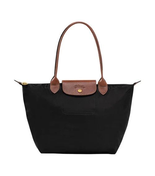 Longchamp Le Pliage Nylon Tote Bag Black Large (Category: Luxury Bags & Wallets) located in Pila. Submitted by stassie_ (Listing ID 1471145183, Image 2). Description: - Brand: Longchamp Le Pliage Tote Bag - Color: Classic black nylon with brown leather handles and flap - Condition: Brand new, still sealed in original packaging with barcode sticker attached - Features: Durable, lightweight everyday shoulder bag with secure zip top and snap button 