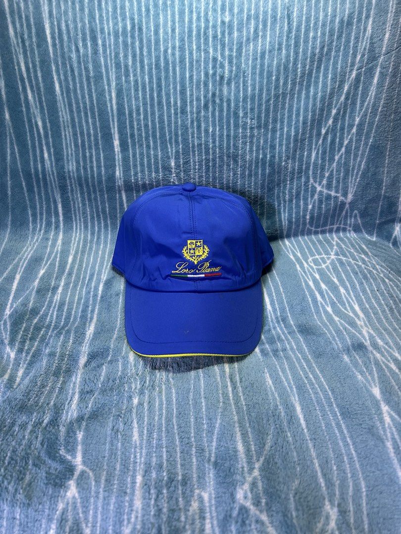 Loro Piana Storm System Baseball Cap Blue (Category: Caps & Hats) located in Quezon City. Submitted by thriftxgoods (Listing ID 1471252642, Image 1). Description: - Authentic Loro Piana baseball cap in royal blue - Embroidered crest and Italian flag detail on the front - Contrast yellow underside on the brim - Signature plaid pattern lining with Storm System tag - Made in Italy - Adjustable elastic back strap for a comfortable fit - Excellent, cl
