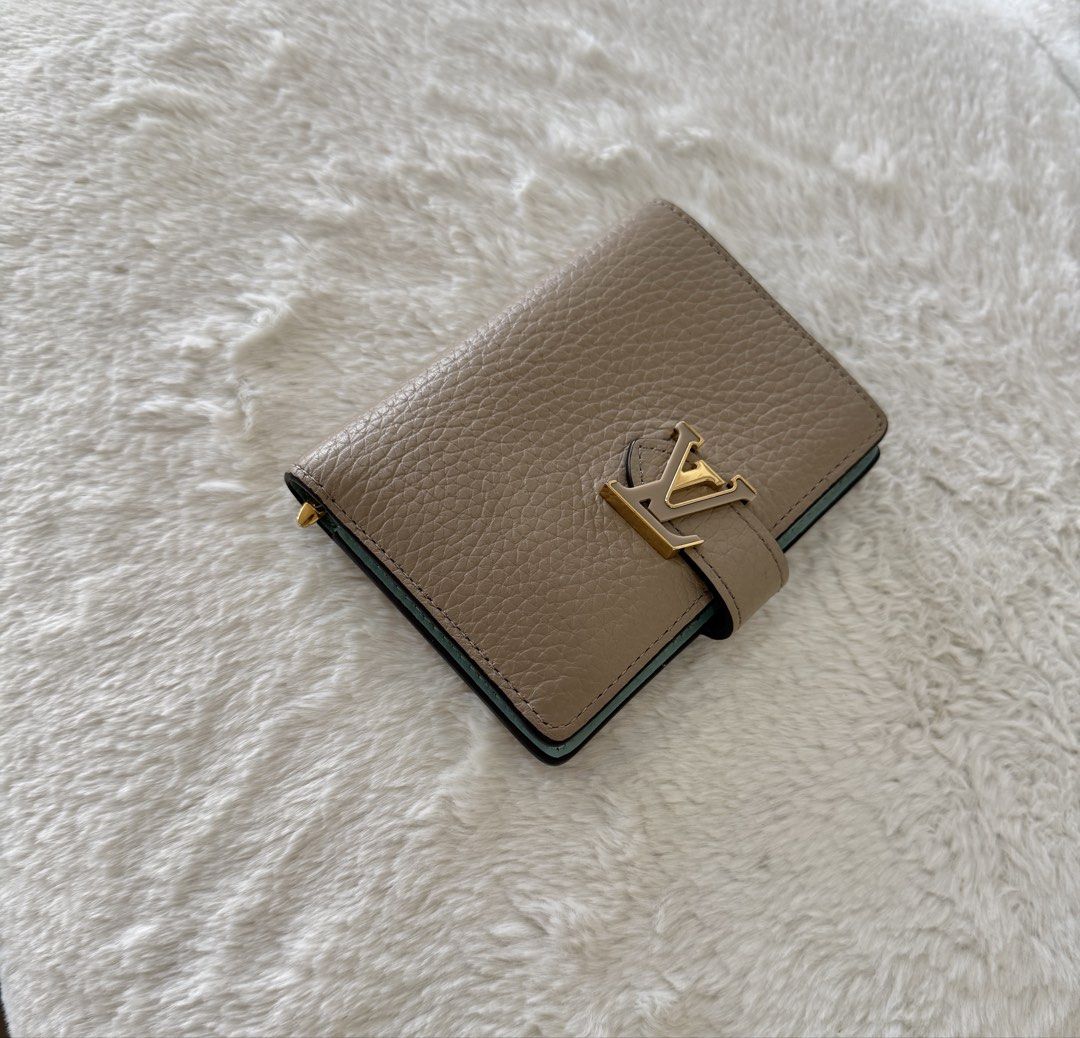 Louis Vuitton Capucine Compact Wallet (Category: Luxury Bags & Wallets) located in Quezon City. Submitted by closet24 (Listing ID 1471295973, Image 2). Description: - Taurillon Leather - Galet Gray (exterior) / Aquamarine blue -Gold hardware -6 card slots -Zipped coin pocket Retails for 60k++ on website 8.9/10 Very minimal signs of use Inclusions Box, dust bag, gift card Slightly nego posted it low.