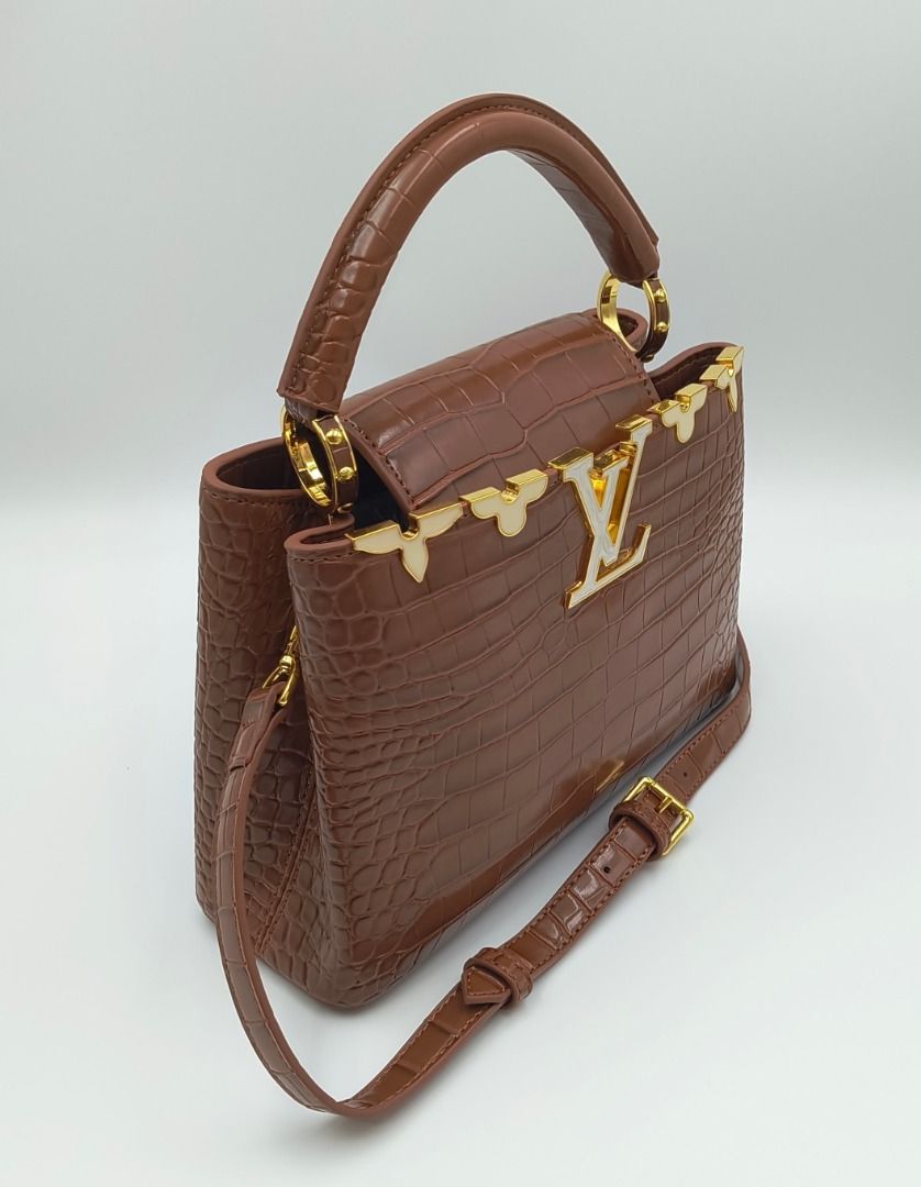 Louis Vuitton Capucines BB Flower Crown Croc Brown (Category: Luxury Bags & Wallets) located in Cebu City. Submitted by affordabagss (Listing ID 1471186844, Image 2). Description: Louis Vuitton Capucines BB Flower Crown Top Handle Bag in cognac brown crocodile-embossed leather with a structured silhouette. The design features a signature LV emblem, distinctive flower crown detailing, and gold-tone hardware with white enamel accents. A curved leat