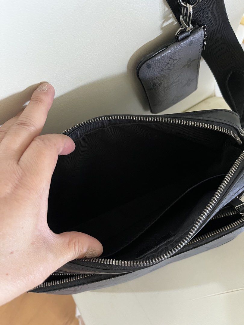 Louis Vuitton Monogram Eclipse M69443 Trio Messenger Bag (Category: Luxury Bags & Wallets) located in Manila. Submitted by summerjes0609 (Listing ID 1471167227, Image 2). Description: Authentic Louis Vuitton messenger bag in Monogram Eclipse canvas. Features a sleek dark grey and black design with silver hardware, multiple zip compartments, and a handy removable pouch on the adjustable strap. Perfect for daily use. Very good condition.