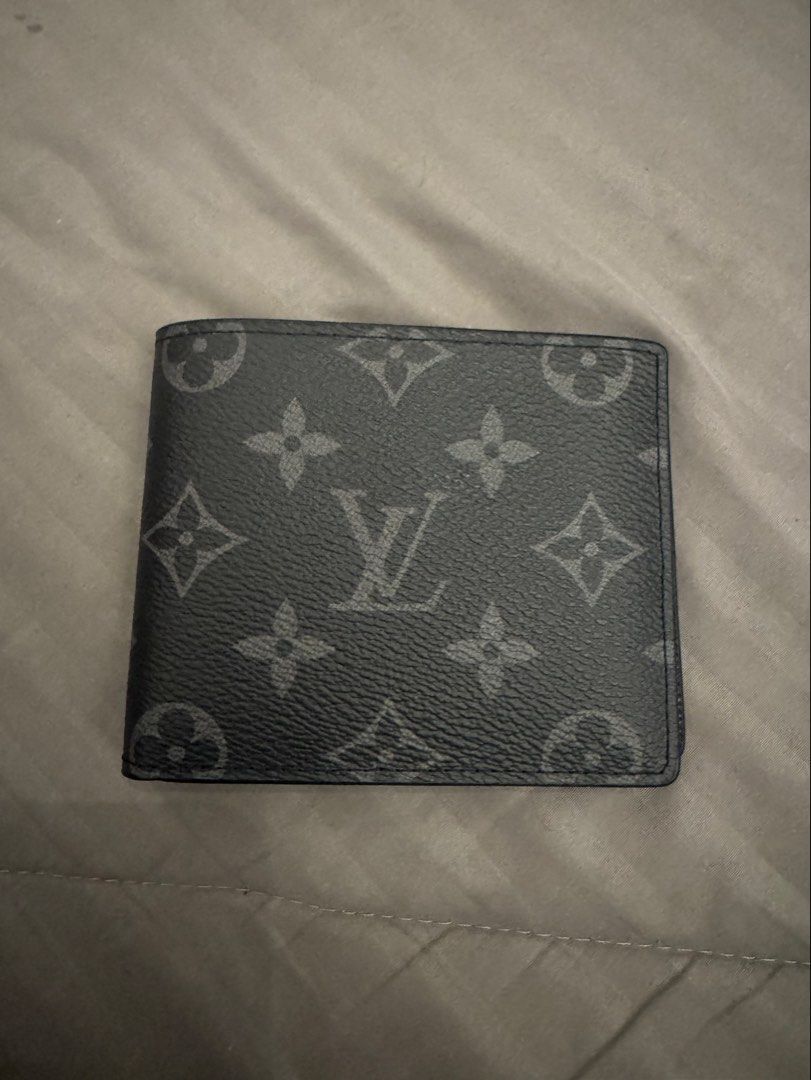 Louis Vuitton Monogram Eclipse Multiple Wallet (Category: Wallets & Card Holders) located in Kuala Lumpur. Submitted by syncronixed (Listing ID 1471256969, Image 1). Description: - Brand: Louis Vuitton - Model: Multiple Wallet - Material: Monogram Eclipse canvas - Color: Dark grey and black - Condition: Brand new with protective foam inserts intact - Design: Compact bi-fold with multiple card slots and compartments - Interior: Clean black lining 