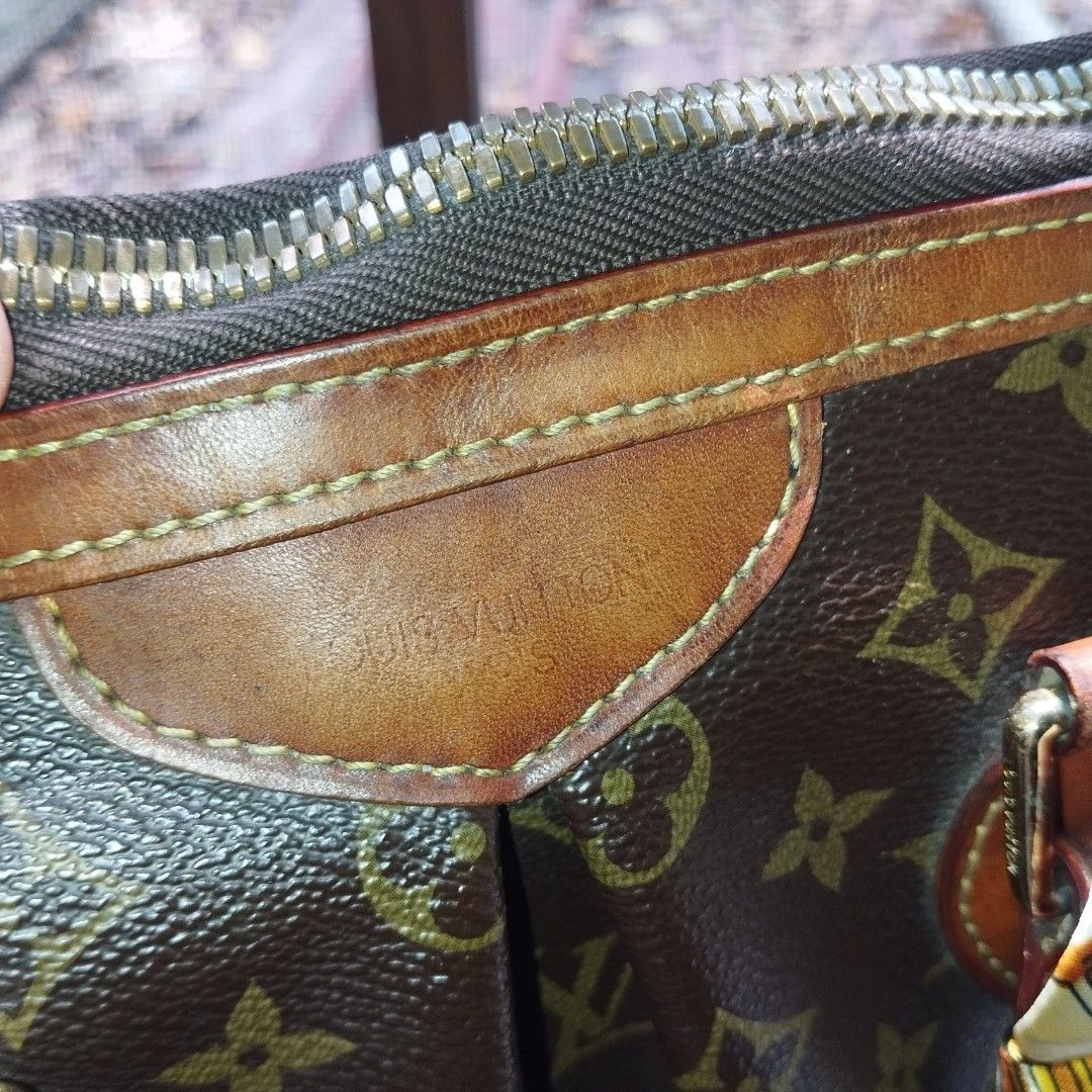 Louis Vuitton Monogram Tote Bag with Twilly Scarf (Category: Tote Bags) located in Manila. Submitted by lene48 (Listing ID 1471223645, Image 3). Description: - Classic brown monogram canvas with leather trim - Secure zip top closure - Wrapped handles adorned with a chic printed twilly scarf - Elegant gold-tone hardware details - Spacious interior, perfect for daily essentials - medium size, with code.