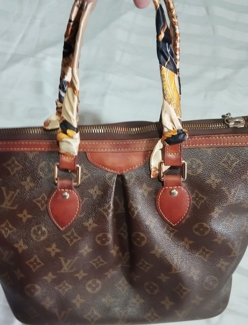Louis Vuitton Monogram Tote Bag with Twilly Scarf (Category: Tote Bags) located in Manila. Submitted by lene48 (Listing ID 1471223645, Image 1). Description: - Classic brown monogram canvas with leather trim - Secure zip top closure - Wrapped handles adorned with a chic printed twilly scarf - Elegant gold-tone hardware details - Spacious interior, perfect for daily essentials - medium size, with code.
