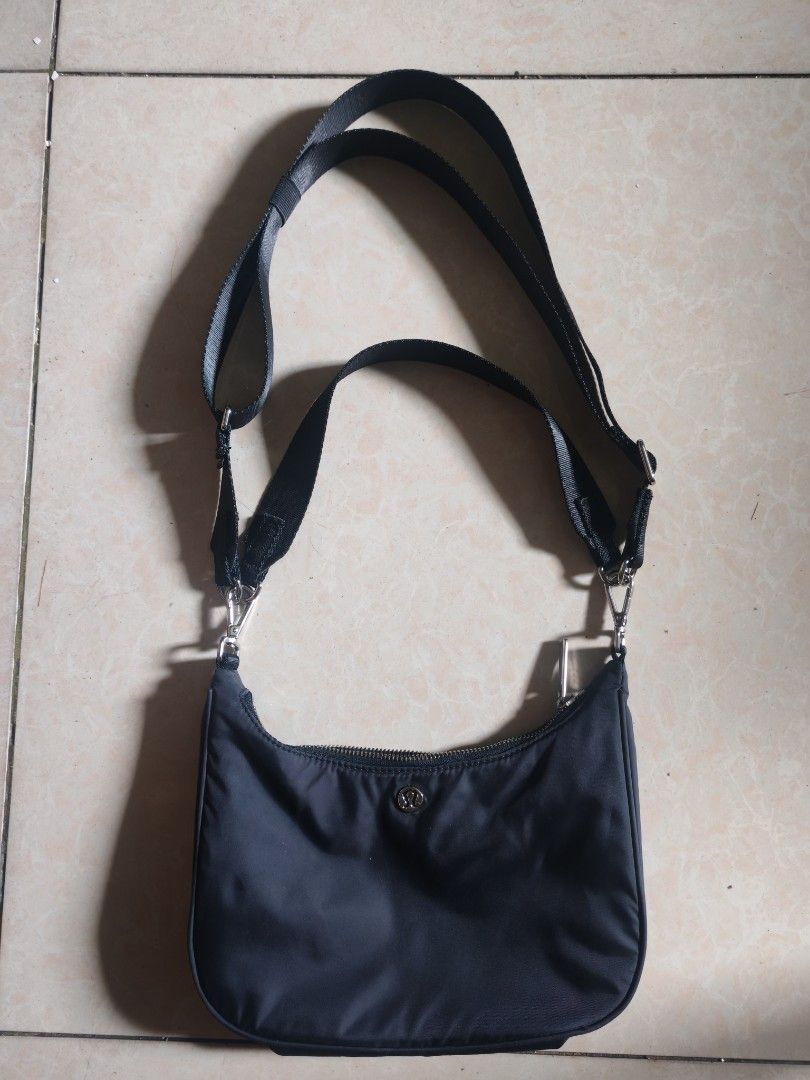 Lululemon Black Nylon Crossbody Shoulder Bag (Category: Cross-body Bags) located in Taguig. Submitted by valentinekiwi (Listing ID 1471126535, Image 2). Description: - Brand: Lululemon two way bag - Style: Compact crescent crossbody shoulder bag - Color: Classic black - Material: Durable nylon - Hardware: Silver-tone with metal clips and front logo emblem - Closure: Main zippered compartment - Strap: Adjustable for a custom fit - Condition: Excel