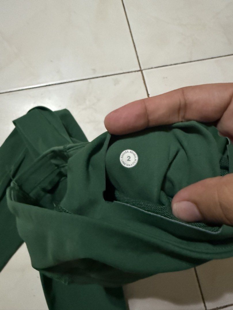 Lululemon Green Leggings Size 2 (Category: Activewear) located in Davao. Submitted by nobleangel (Listing ID 1471137444, Image 3). Description: - Brand: Lululemon - Color: Dark Green - Size: 2 (tag inside waistband) - Fit: High-rise with small waistband pocket - Details: Classic Lulu logo on back leg - Fabric: Soft and stretchy, perfect for workouts or daily wear.