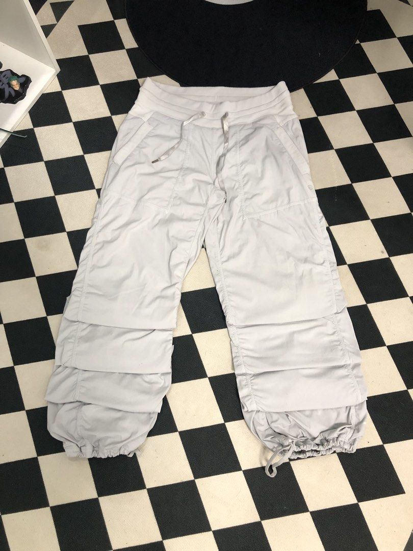 Lululemon Light Grey Jogger Pants Dimes: 28X34 (Category: Joggers) located in Manila. Submitted by ejaay_2012 (Listing ID 1471154696, Image 1). Description: - Brand: Lululemon - Color: Light grey - Style: Cargo jogger pants with elastic waistband and adjustable drawstring - Features: Multiple layered utility pockets, adjustable drawstring hems - Condition: Flaws include noticeable crackling/peeling on the printed logo near the bottom hem and a mi