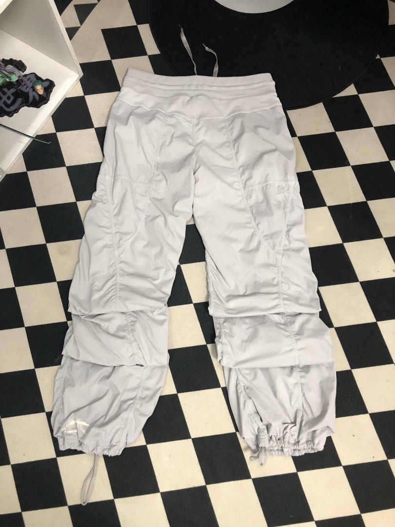 Lululemon Light Grey Jogger Pants Dimes: 28X34 (Category: Joggers) located in Manila. Submitted by ejaay_2012 (Listing ID 1471154696, Image 3). Description: - Brand: Lululemon - Color: Light grey - Style: Cargo jogger pants with elastic waistband and adjustable drawstring - Features: Multiple layered utility pockets, adjustable drawstring hems - Condition: Flaws include noticeable crackling/peeling on the printed logo near the bottom hem and a mi