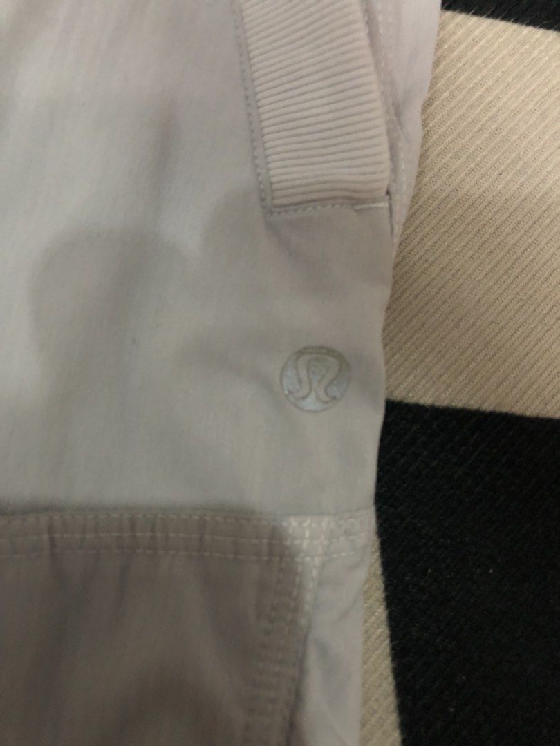 Lululemon Light Grey Jogger Pants Dimes: 28X34 (Category: Joggers) located in Manila. Submitted by ejaay_2012 (Listing ID 1471154696, Image 2). Description: - Brand: Lululemon - Color: Light grey - Style: Cargo jogger pants with elastic waistband and adjustable drawstring - Features: Multiple layered utility pockets, adjustable drawstring hems - Condition: Flaws include noticeable crackling/peeling on the printed logo near the bottom hem and a mi