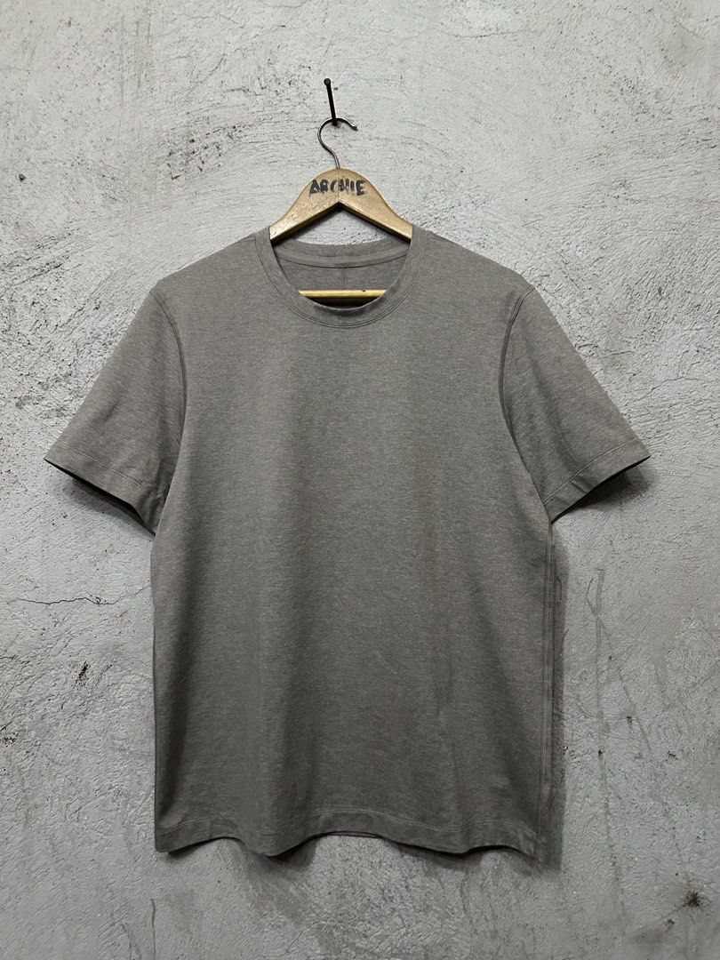 Lululemon Men's Grey Athletic T-Shirt (Category: Tshirts & Polo Shirts ) located in Quezon City. Submitted by stre3tw3ar (Listing ID 1471273313, Image 1). Description: - Brand: Lululemon - Style: Men's short sleeve athletic t-shirt - Color: Grey marl - Details: Round neckline, signature logo printed near the sleeve hem - Material: Breathable athletic fabric - Condition: Clean overall, great for gym or everyday wear.
