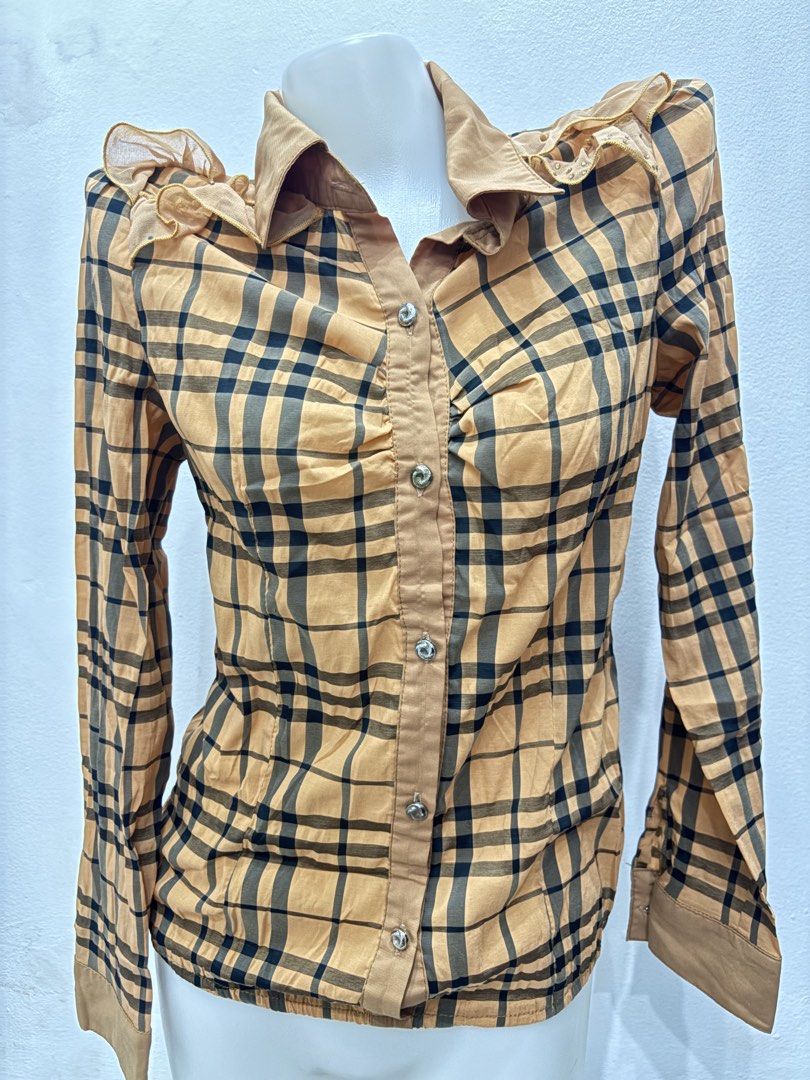 M Vintage Plaid Button-Down Blouse with Ruffled Shoulders (Category: Blouses) located in Manila. Submitted by urechicthrftmnl (Listing ID 1471166719, Image 3). Description: - Color & Pattern: Tan and black plaid - Closure: Front button closure with gathered ruching down the placket - Details: Ruffled mesh shoulders with tiny stud embellishments - Back Accent: Vertical strip of rhinestones down the center back - Cuffs: Button cuffs for an adjustab