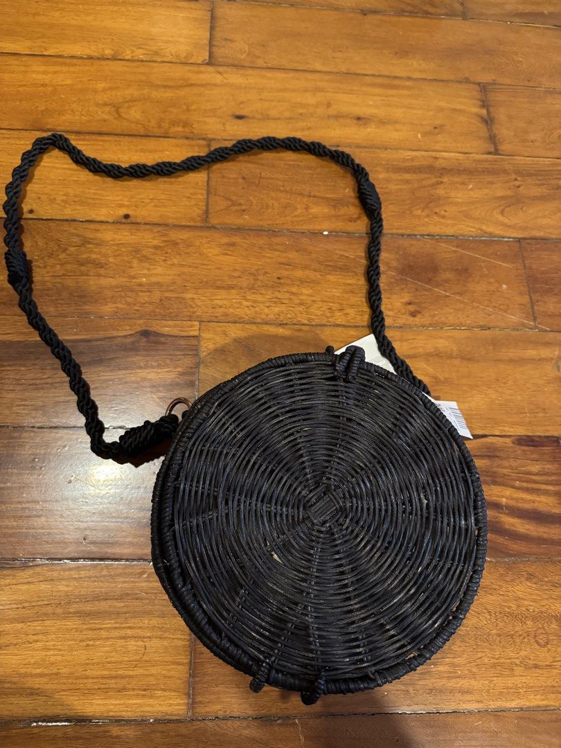 Mango Black Round Woven Crossbody Bag (Category: Cross-body Bags) located in Manila. Submitted by coclosets (Listing ID 1471200469, Image 1). Description: - Originally ₱2500 - Brand: Mango (Original store tag still attached) - Style: Round woven straw crossbody bag in classic black - Versatile carry: Includes both top handles and a woven shoulder strap - Closure: Secure front loop closure - Interior: Solid black lining with Mango fabric brand tag