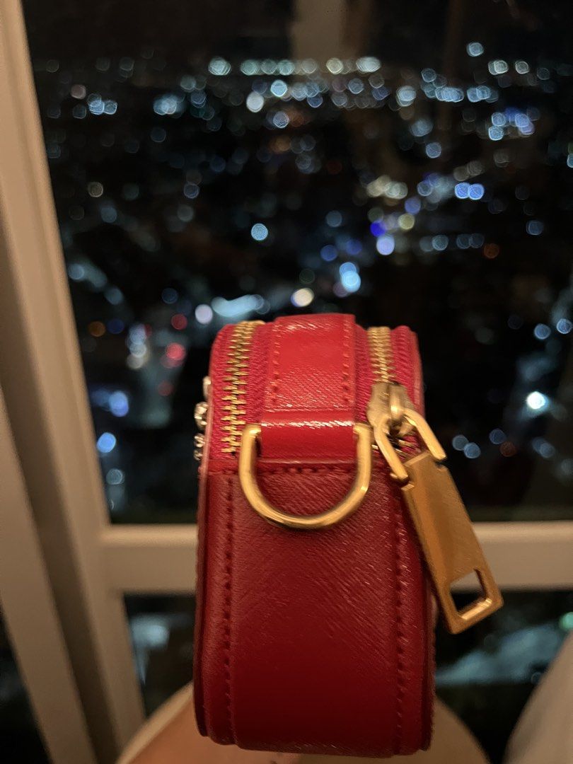 Marc Jacobs Red Snapshot Camera Bag with Embellishments (Category: Other Accessories) located in Imus. Submitted by ann__xoxo (Listing ID 1471179267, Image 3). Description: - Brand: Marc Jacobs - Style: Crossbody Camera Bag - Color: Red with gold hardware - Material: Durable Saffiano leather - Design: Unique sequin hand graphic and rhinestone bead details with gold foil branding - Compartments: Double zip compartments - Inclusion: Matching red st
