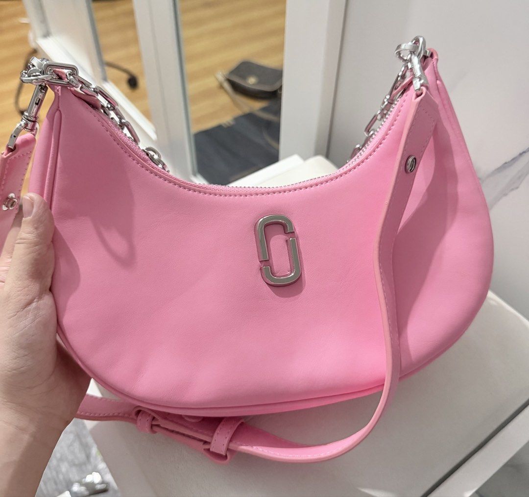 Marc Jacobs The J Marc Curve Shoulder Bag (Category: Shoulder Bags) located in Manila. Submitted by prelovedbygayle (Listing ID 1471285161, Image 2). Description: • Silhouette: Sculpted in an elegant, modern crescent moon or “hobo” slouchy curved shape. • Hardware & Logo: Accented with a sleek, vertically oriented oval interlocking “J Marc” metal logo plaque centered on the front. The hardware and chains are finished in a polished silver tone. • 