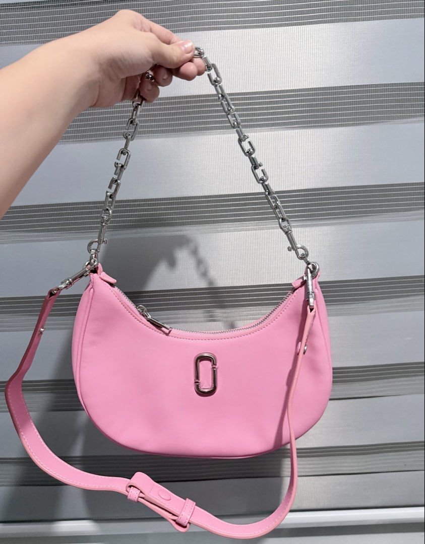 Marc Jacobs The J Marc Curve Shoulder Bag (Category: Shoulder Bags) located in Manila. Submitted by prelovedbygayle (Listing ID 1471285161, Image 1). Description: • Silhouette: Sculpted in an elegant, modern crescent moon or “hobo” slouchy curved shape. • Hardware & Logo: Accented with a sleek, vertically oriented oval interlocking “J Marc” metal logo plaque centered on the front. The hardware and chains are finished in a polished silver tone. • 