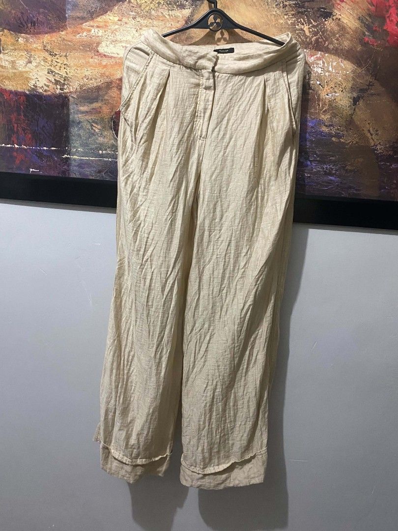 Massimo Dutti wide-leg cuffed trousers (Category: Trousers) located in Iba. Submitted by yunqiz (Listing ID 1471278488, Image 1). Description: Outer Shell: 87% Linen, 13% Polyamide (Nylon) — providing a lightweight, breathable linen texture with added durability and wrinkle resistance. Lining: 51% Acetate, 49% Viscose. Design Details: High-waisted silhouette with front pleats, hidden zip fly with hook-and-eye closure, side pockets, rear welt pock
