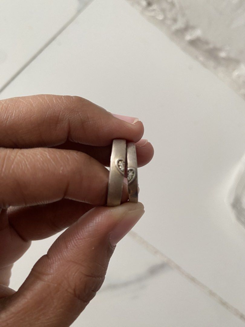 Matching Couple Heart Crystal Silver Rings Set (Category: Rings) located in Bulacan. Submitted by prelovedbyjgs (Listing ID 1471199984, Image 2). Description: - Matching silver couple rings featuring cute heart cutouts with tiny crystals - One band is slightly thicker for a comfortable fit for him/her - Pre-owned condition with minor signs of wear and light tarnish spots - Can easily be polished and brightened up with silver cleaner - Perfect aff