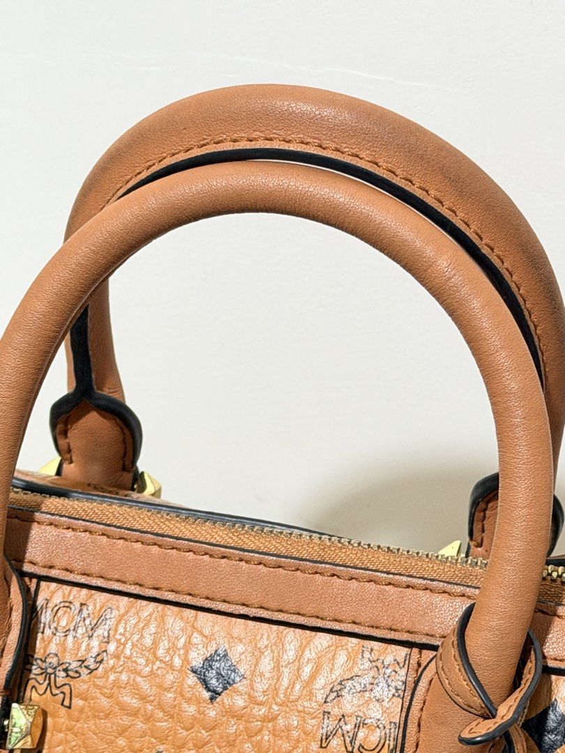 MCM Cognac Visetos Boston Bag (Category: Luxury Bags & Wallets) located in Paranaque City. Submitted by diannmlee (Listing ID 1471207170, Image 3). Description: Needs cleaning Sign of usage No sling I bought this sa Tiktok live selling ng ukay bags and never used it. Impulse buy lang. It looks and feels legit. I am not 💯 sure though. Bag condition: 7.5/10.